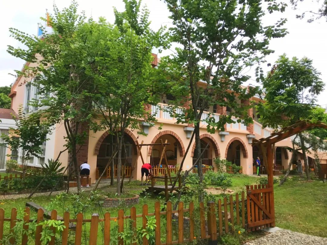 一个有大片绿地、果树、鱼塘、菜地，还有小鸡和鸭子的小岛幼儿园